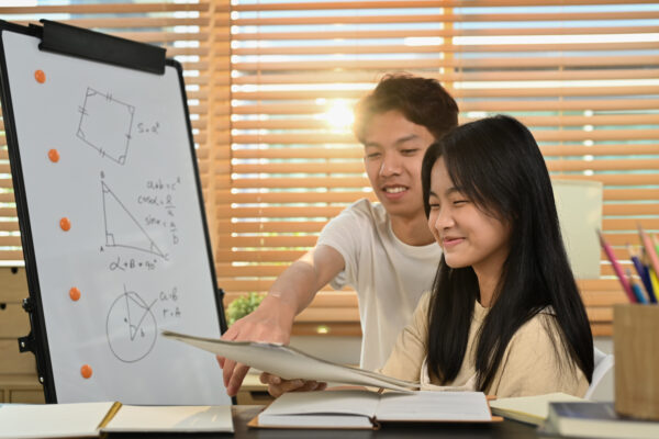 Teen student receiving ADHD math tutoring support with geometry homework at home